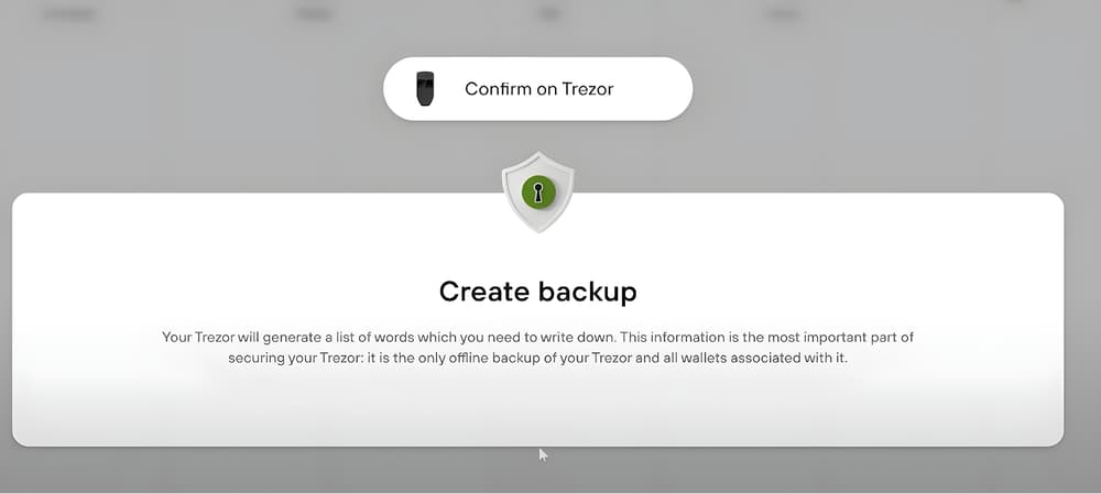 Το Trezor Suite περιμένει όσο η συσκευή εμφανίζει τις λέξεις ανάκτησης